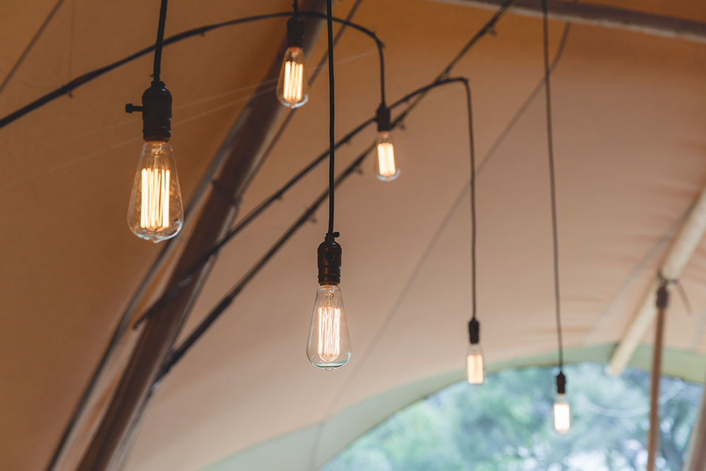 Gather and Gold tipi events - hanging lights inside tipi for the Jeep Wrangler launch event in Otago, New Zealand.