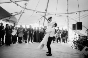 Gather and Gold tipi hire near me - black and white bride and groom lift on dance floor