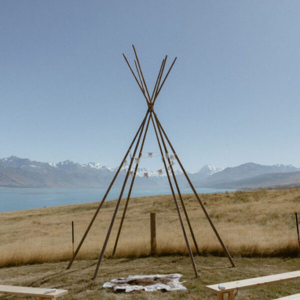 Gather and Gold small tipi hire - ceremony arbour set up for a wedding in Queenstown with lake behind
