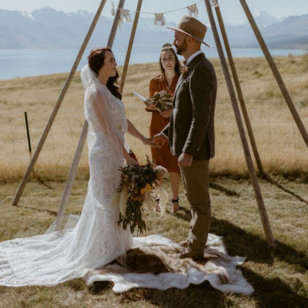 Gather and Gold teepee hire wedding - bride and groom saying vows in front of ceremony arbour