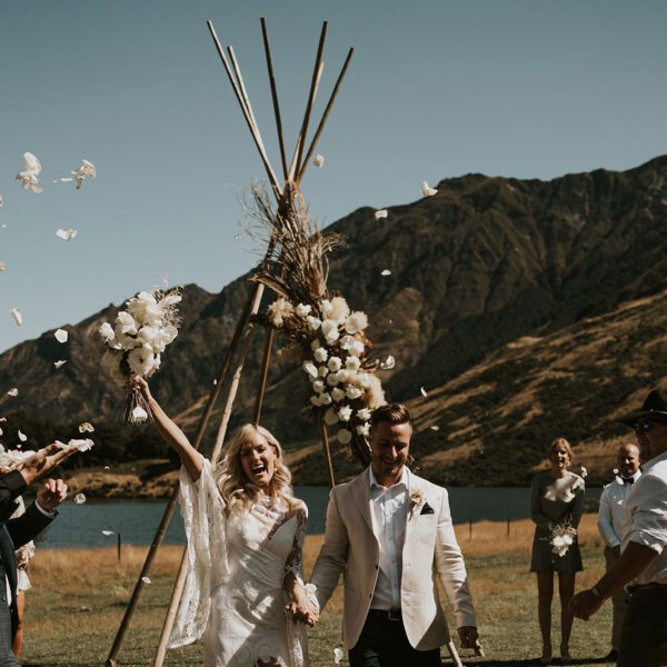 Gather and Gold tipi tent hire - ceremony arbour behind bride and groom in Wanaka
