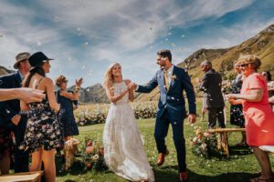 Gather and Gold teepee wedding venue - bride and groom just married walking down the aisle under confetti