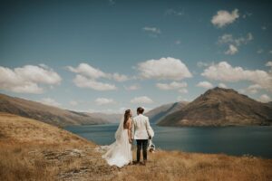 Gather and Gold bell tent wedding - bride and groom overlooking the lake in Queenstown