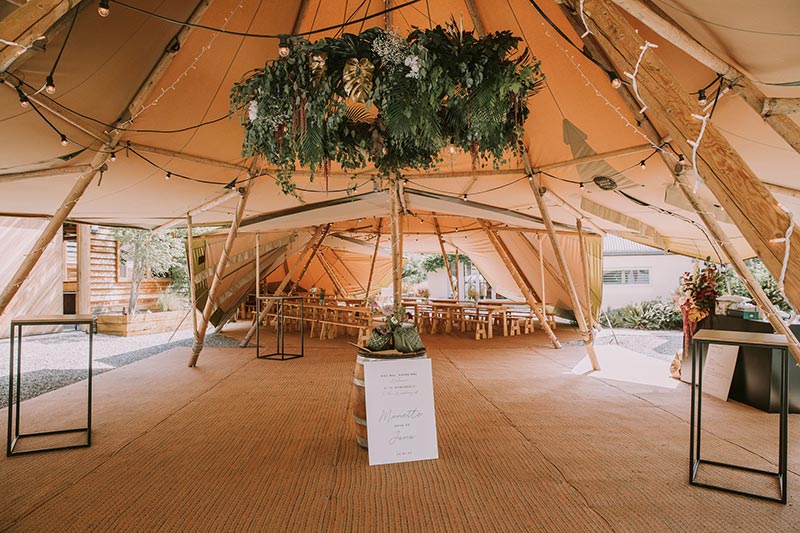 Beautiful tipi set up with flowers and lights for modern tipi wedding in Queenstown by Gather and Gold