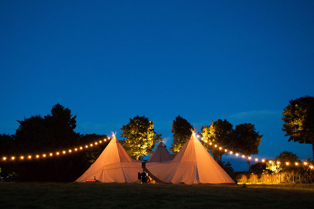 Gather and Gold large teepee tent hire - 3 teepees and strings of lights in the evening light