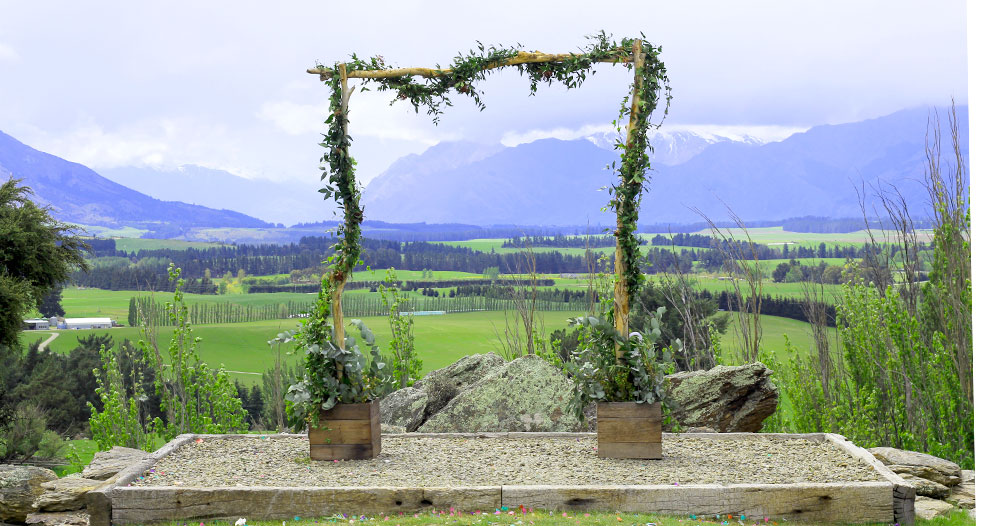 Gather and Gold teepee wedding venue - ivy frame alter with beautiful views of Queenstown behind