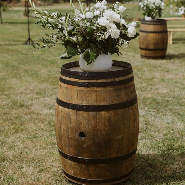 Gather and Gold event tipi hire - floral display on a wine barrel