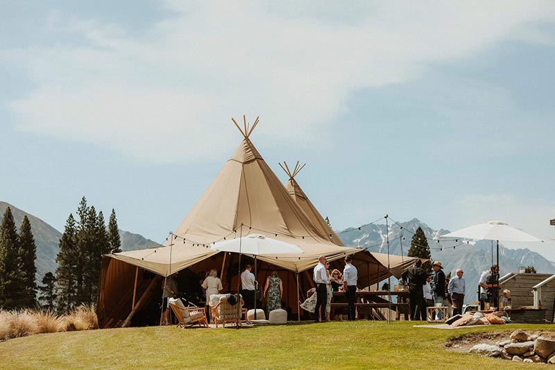 Stunning tipi wedding in large bell tent with mountains in the background - by Gather and Gold