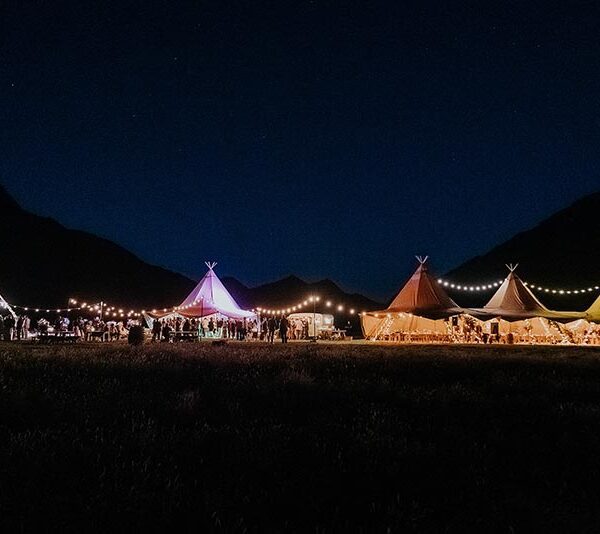 Multiple Tipis lit up at night - hire tipis from Gather and Gold