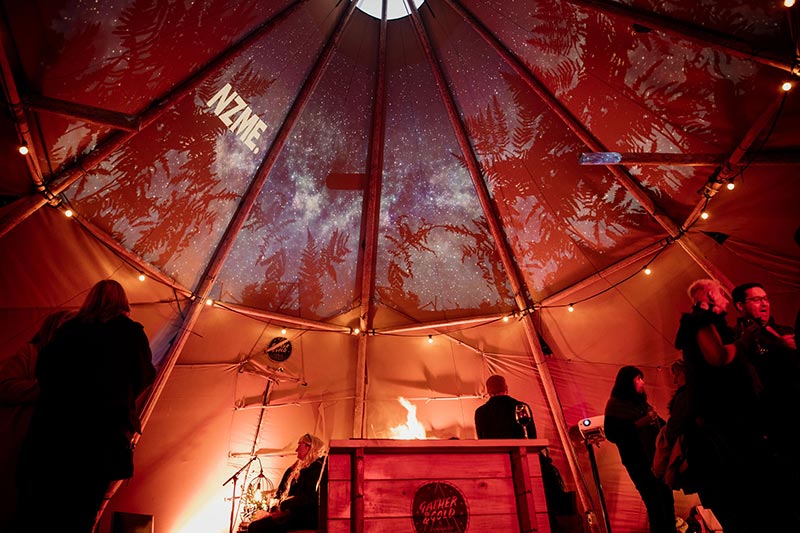 NZME corporate event with projection of the logo on the inside a Gather and Gold tipi