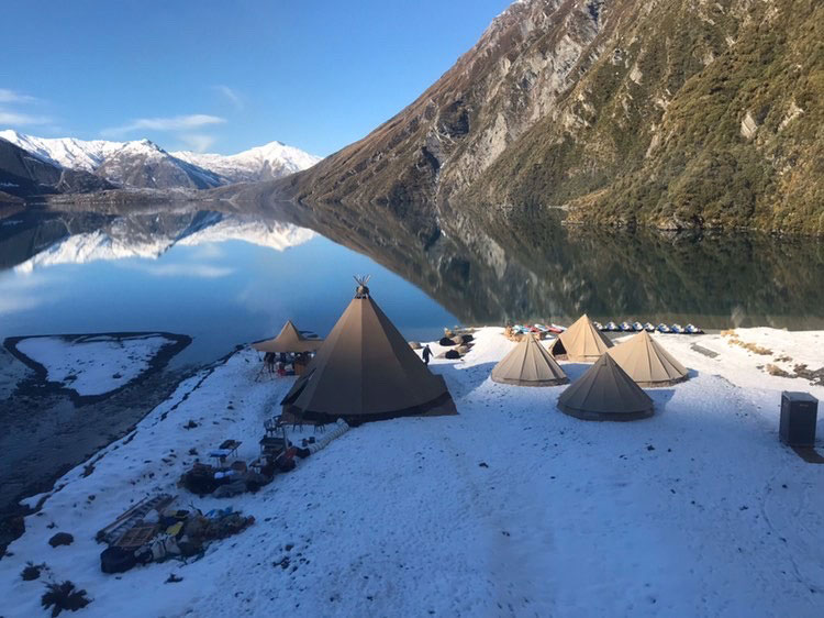 Gather and Gold Tipis beside a lake in the south island with kayaks