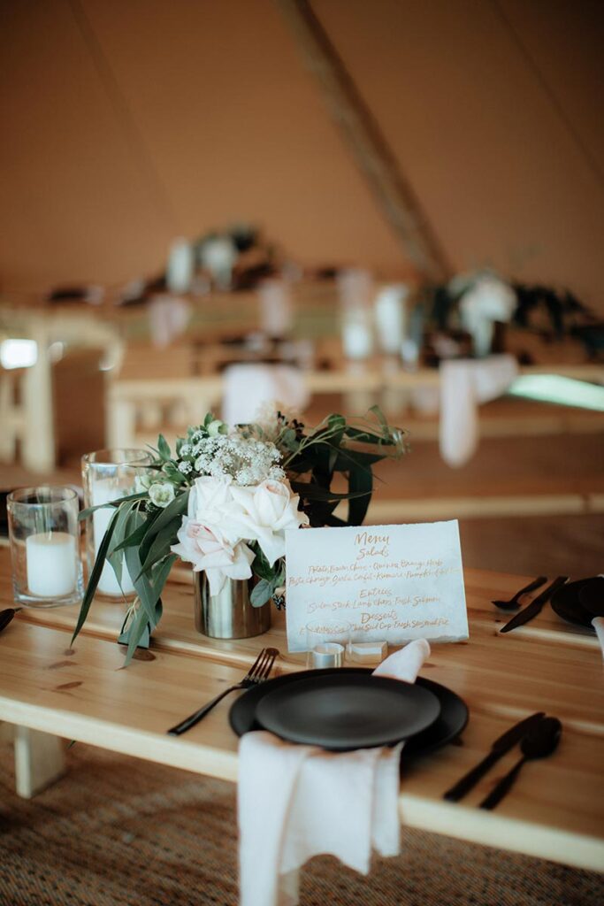 Wedding table settings in a Gather and Gold tipi