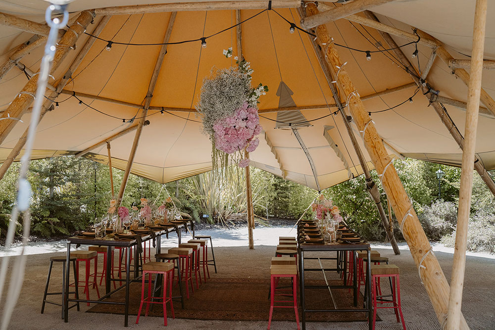 Wedding reception table settings in a Gather and Gold tipi
