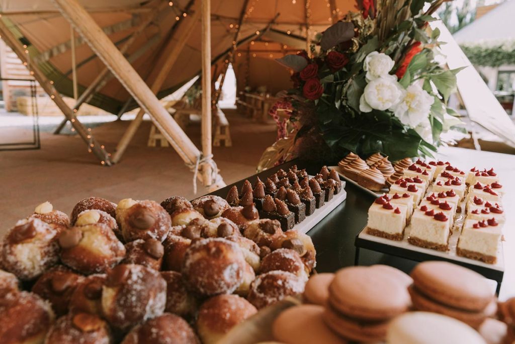 Gather and Gold Teepees recommends Flower, caterers and wedding planners in Queenstown and Wanaka - dessert table filled with cakes and slices set up in tipi.