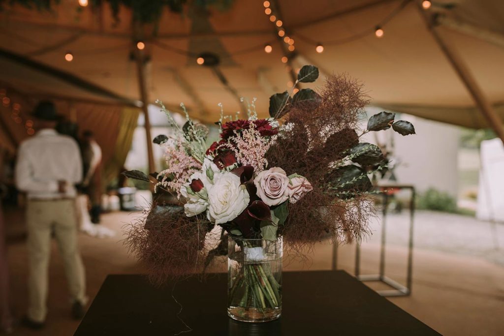 Flowers, Caterers, and Wedding Planners - internal teepee floral arrangement and fairy lights