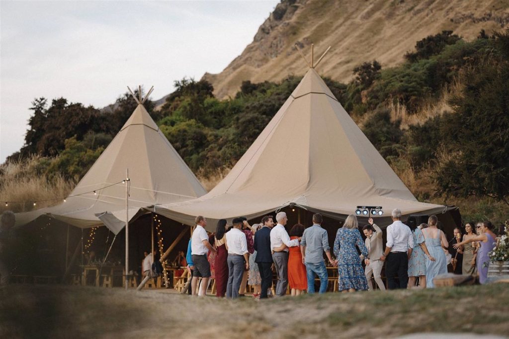 Fairytale tipi wedding in Hawea, South Island, New Zealand. Multiple tipi tent arrangement for wedding reception.  