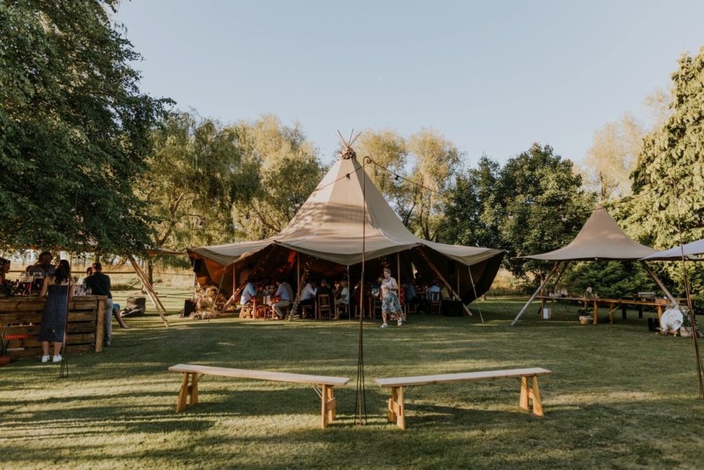 A tipi set-up on a lawn in someones garden